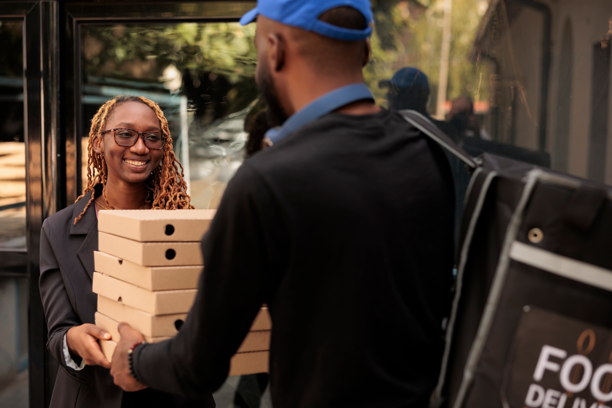 Business lunch delivery, cheerful client holding pizza boxes pile